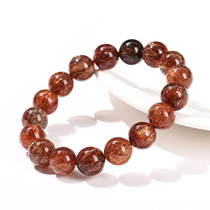 black gold super 7 bracelet made of polished round reddish brown rutilated crystal beads on stretch cord