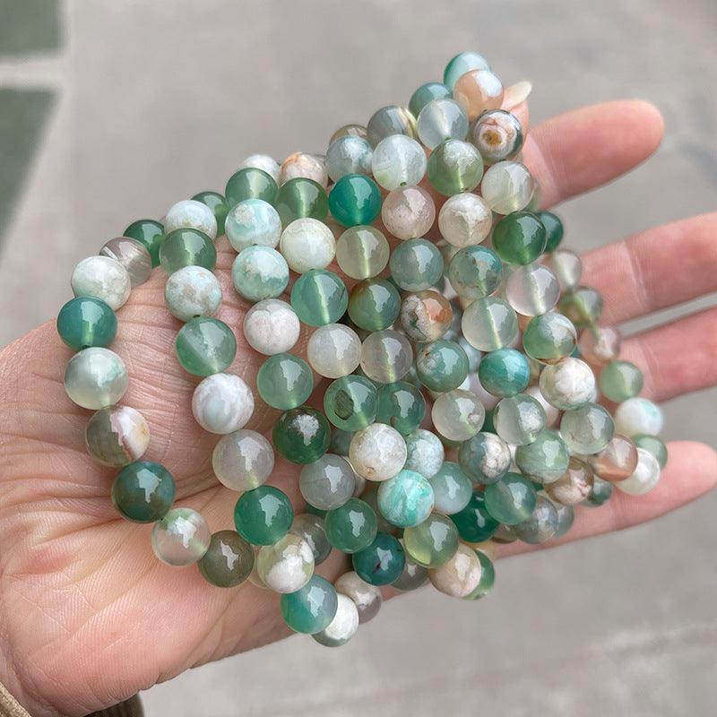 MLD Wholesale Crystals polished green and white bead strands of wholesale flower agate bracelet held in hand