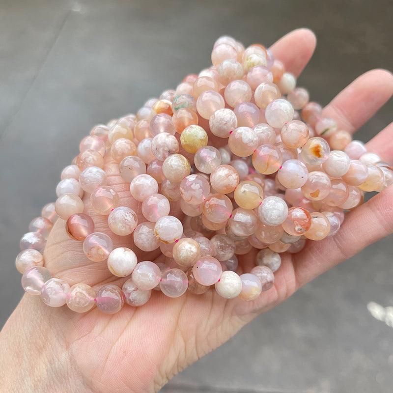 MLD Wholesale Crystals wholesale flower agate bracelet strands of pink round beads held in hand