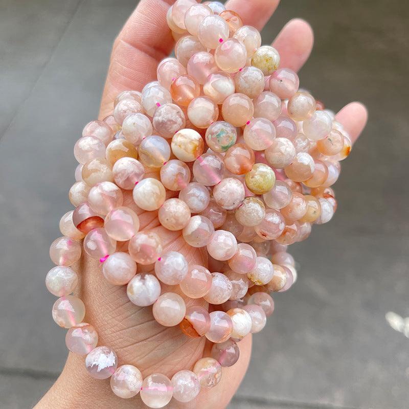 MLD Wholesale Crystals wholesale flower agate bracelet polished pink and peach round bead strands held in hand