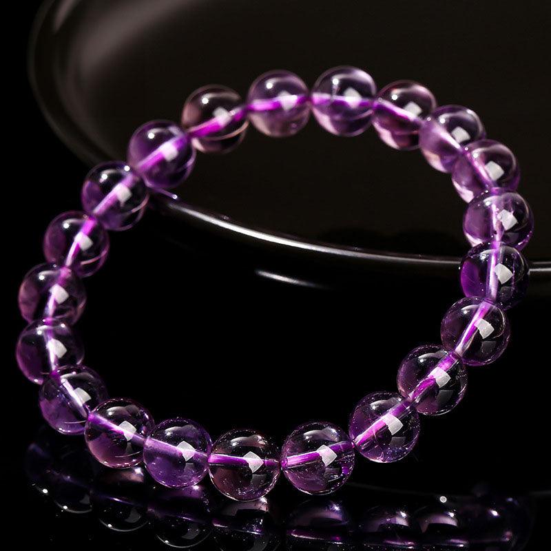 Round polished beaded stretch wholesale amethyst bracelet with translucent purple beads on black
