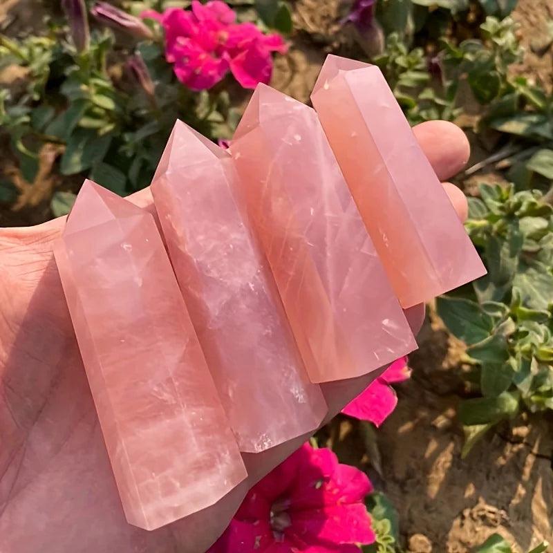MLD Wholesale Crystals wholesale rose quartz tower set of four polished points held in hand with pink flowers
