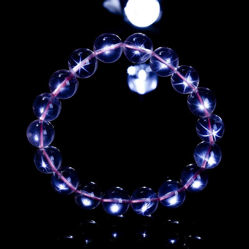 MLD Crystals wholesale rose quartz star bracelet with round translucent pink beads and star reflection on black background