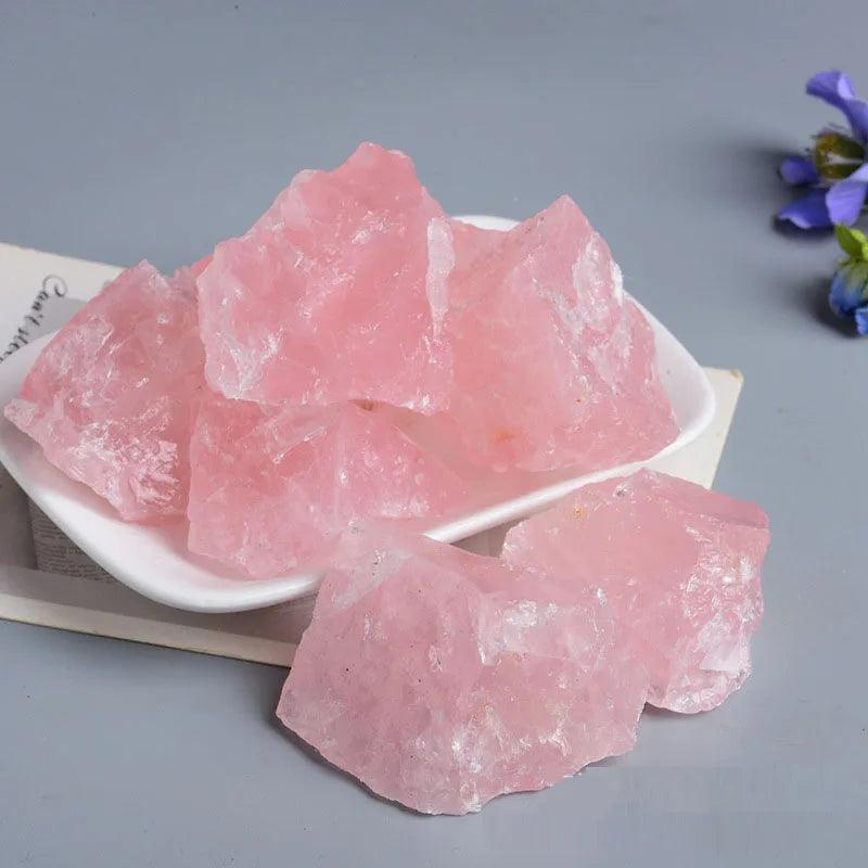Pink raw rose quartz chunks on a white dish for decor and crystal healing wholesale rose quartz raw stones