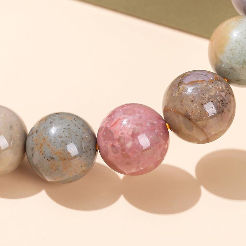 Alashan agate bracelet wholesale polished multicolor round beads close up showing pink gray and brown agate spheres